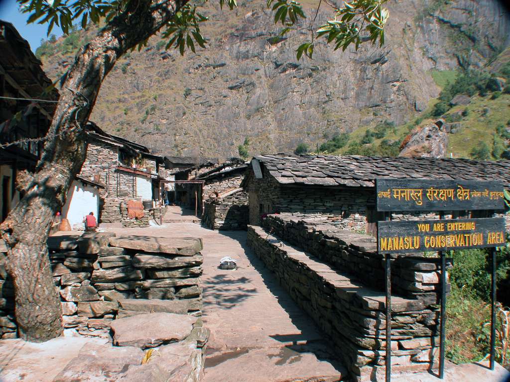 Manaslu 04 01 Jagat I spoke to a local shop owner in Jagat who told me you don't need a government permit to enter the Manaslu Conservation Area anymore. The government officials have fled the area, leaving it to the Maoists. The town of Jagat (1415m), with the local school on the far right, is fixed with paved stone plates throughout.